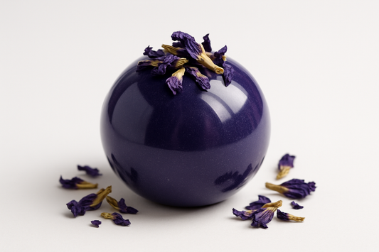 can you make a pic of a Butterfly Pea Tea Bomb in a glossy bomb with purpule dried floder on and withe background