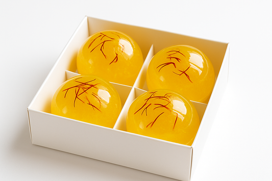 can you make a Picture of 4 saffran teabombs made in glykosbomb in a White easy giftbox with White background