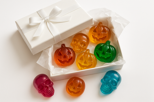 kan du göra en bild på en vit gift box med vit gift papper under med 6 Chrystal candys i formerna dödskalle och pumpkin ansikte med vit bakground